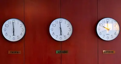 three clocks on a wall with different time zones at Sky Hotel Flushing/Laguardia Airport in Queens