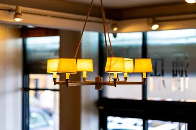 a chandelier with yellow lights hanging from a ceiling at Sky Hotel Flushing/Laguardia Airport in Queens