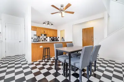a kitchen and dining room with a table and chairs at Exquisite Downtown Loft Apartment in Hartford