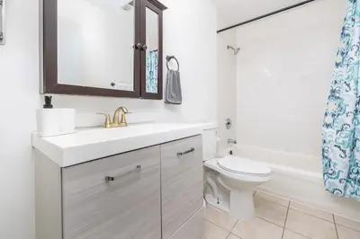 a white bathroom with a sink and a toilet at Exquisite Downtown Loft Apartment in Hartford