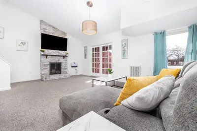 a living room with a couch and a fireplace at Exquisite Downtown Loft Apartment in Hartford