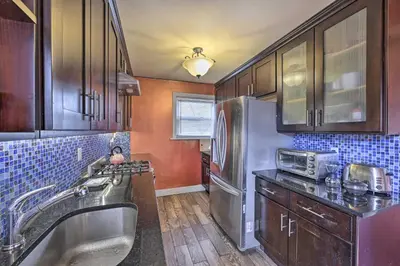 a kitchen with a sink and a stainless steel refrigerator at Charming New York Escape Near Central Park! in Jericho
