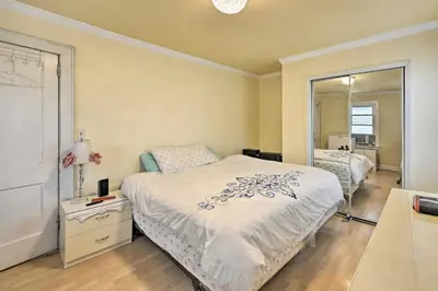 a bedroom with a bed and a large mirror at Charming New York Escape Near Central Park! in Jericho