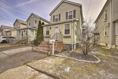 a house with a staircase in front of it at Charming New York Escape Near Central Park! in Jericho