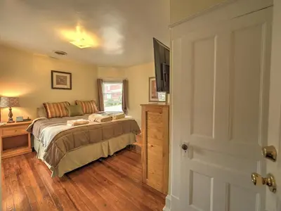a bedroom with a bed and a flat screen tv at 1st Base Apt 2 All Star Baseball Rentals in Oneonta