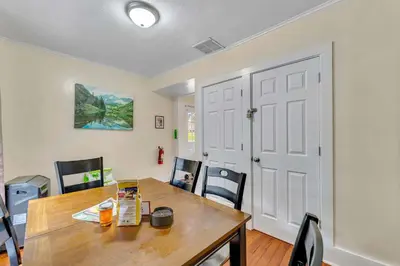 a dining room with a wooden table and chairs at The Hill All Star Baseball Rentals in Oneonta