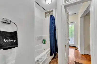 a bathroom with a blue towel hanging on a wall at The Hill All Star Baseball Rentals in Oneonta