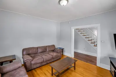 a living room with a couch and a table at The Wheelhouse All Star Baseball Rentals in Oneonta