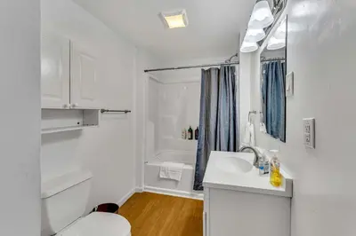 a white bathroom with a sink and a shower at 2nd Base Apt 1 All Star Baseball Rentals in Oneonta