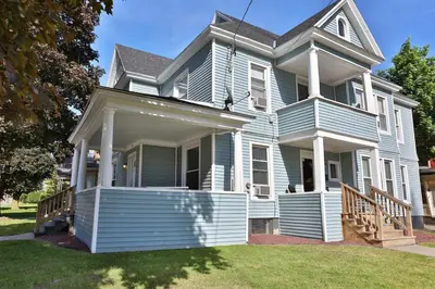 a large blue house with a porch and a yard at 2nd Base Apt 1 All Star Baseball Rentals in Oneonta