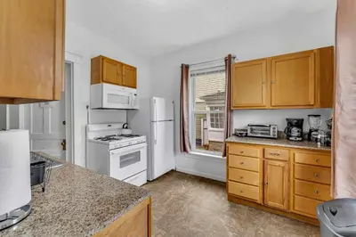 a kitchen with white appliances and a window at 2nd Base Apt 1 All Star Baseball Rentals in Oneonta