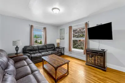 a living room with a couch and a flat screen tv at 2nd Base Apt 2 All Star Baseball Rentals in Oneonta