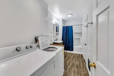 a white laundry room with a washing machine at 2nd Base Apt 2 All Star Baseball Rentals in Oneonta