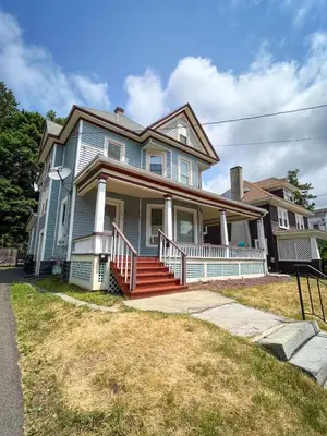 a large blue house with a porch and stairs at After the Game Apt 2 All Star Baseball Rentals in Oneonta