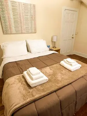 a bed with two towels on top of it at Center Field All Star Baseball Rentals in Oneonta