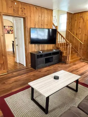 a living room with a tv and a coffee table at Center Field All Star Baseball Rentals in Oneonta