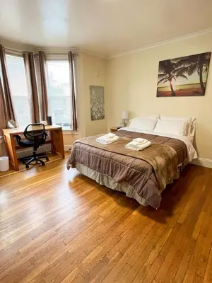 a bedroom with a large bed and a desk at Center Field All Star Baseball Rentals in Oneonta