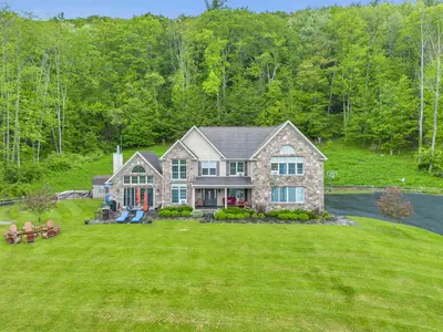 a house with a large yard with green grass at Grand Slam Lake House Cooperstown Dreams Park in Cooperstown