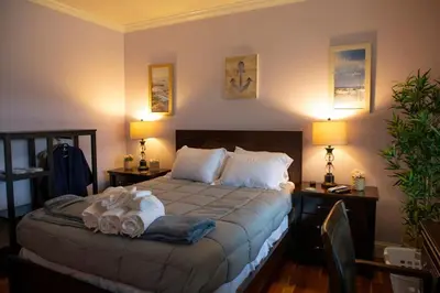a bedroom with a bed with towels on it at Grand Slam Lake House Cooperstown Dreams Park in Cooperstown