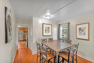 a dining room with a wooden table and chairs at Right Field All Star Baseball Rentals in Oneonta