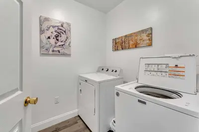 a washer and dryer in a white laundry room at Shortstop Apt 1 All Star Baseball Rentals in Oneonta