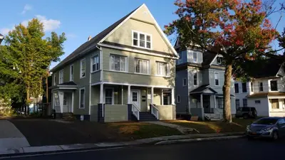a large house with a car parked in front of it at Shortstop Apt 1 All Star Baseball Rentals in Oneonta