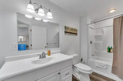 a white bathroom with a sink and a toilet at Shortstop Apt 2 All Star Baseball Rentals in Oneonta