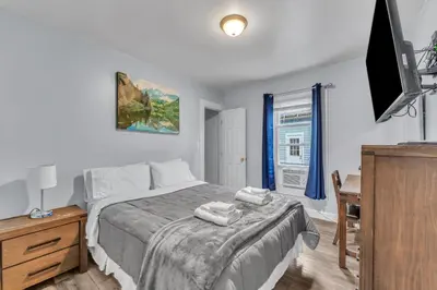 a bedroom with a bed with two towels on it at Shortstop Apt 2 All Star Baseball Rentals in Oneonta