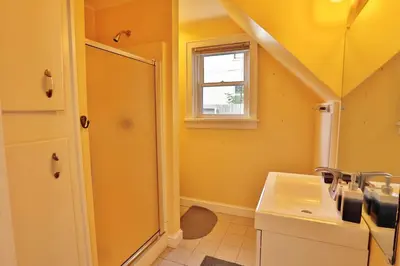 a bathroom with a shower and a sink at The Bullpen All Star Baseball Rentals in Oneonta