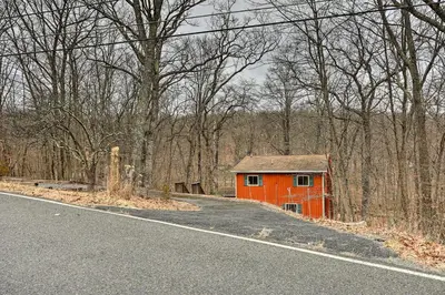 an orange house on the side of a road at 4 Mi to Tubing Cozy Bushkill Cabin with Deck! in Bushkill