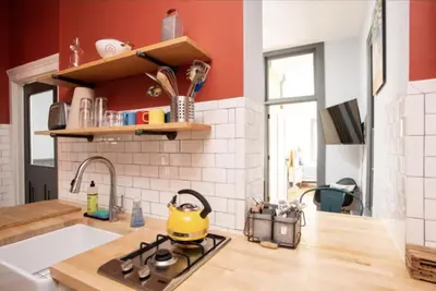 a kitchen with a yellow tea pot on a stove at Hudson Valley Retreat in Downtown Hudson, NY - Sleeps 16-20 in Hudson