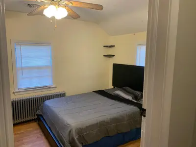 a bedroom with a bed and a ceiling fan at Luke's BnB in Albany