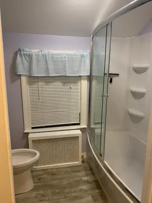 a bathroom with a glass shower and a toilet at Luke's BnB in Albany
