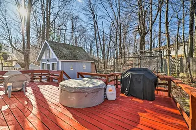 a large wooden deck with a house in the background at Tobyhanna Home Near Kalahari with Lake and Pool Access in Tobyhanna