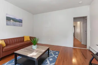 a living room with a couch and a table at Frog Hollow Red Door Retreat in Hartford