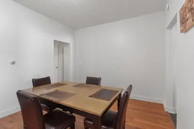 a dining room with a wooden table and chairs at Frog Hollow Red Door Retreat in Hartford