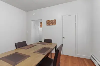 a dining room with a wooden table and chairs at Frog Hollow Red Door Retreat in Hartford