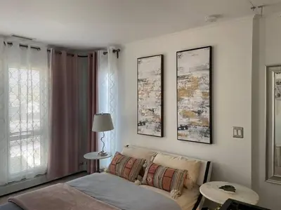 a living room with a bed and a table and a window at Luxury Suite with water view - 2 mini bedrooms in Greenwich