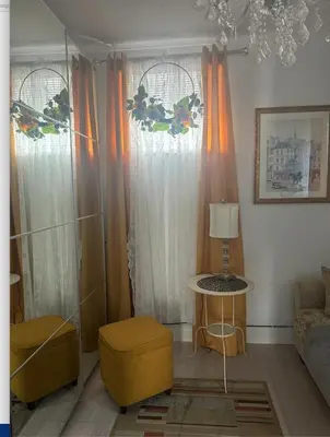 a living room with orange curtains and a couch at Luxury Suite with water view - 2 mini bedrooms in Greenwich