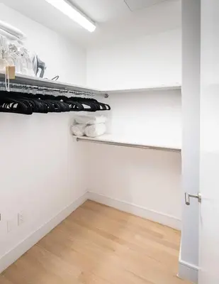 a room with a closet with white walls and a wooden floor at Stunning Penthouse in Chelsea in New York