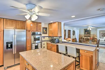 a kitchen with wooden cabinets and a stainless steel refrigerator at All Year-Round Retreat Near Windham Mountain in Conesville