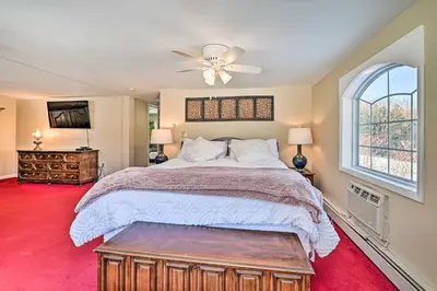 a bedroom with a large bed and a ceiling fan at All Year-Round Retreat Near Windham Mountain in Conesville