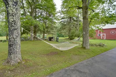a hammock hanging between two trees in a yard at All Year-Round Retreat Near Windham Mountain in Conesville