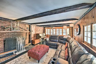 a living room with a couch and a fireplace at All Year-Round Retreat Near Windham Mountain in Conesville