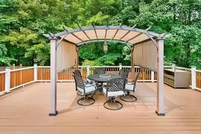a gazebo with a table and chairs on a deck at Cheerful 5-bedroom resort with heated pool in East Stroudsburg