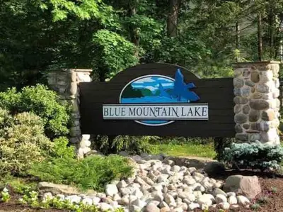 a sign for the blue mountain lake at a park at Cheerful 5-bedroom resort with heated pool in East Stroudsburg