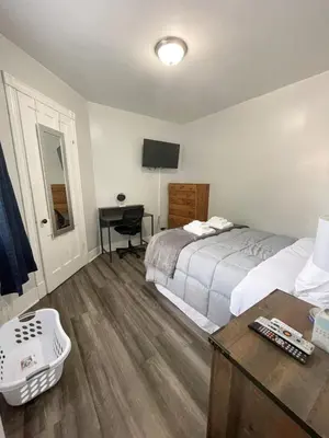 a bedroom with a bed and a desk with a computer at Triple Play Apt 1 All Star Baseball Rentals in Oneonta