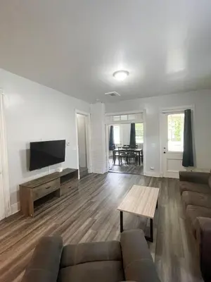 a living room with a couch and a flat screen tv at Triple Play Apt 1 All Star Baseball Rentals in Oneonta
