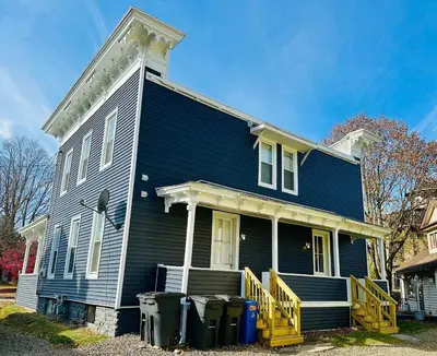 a blue house with trash cans in front of it at Triple Play Apt 1 All Star Baseball Rentals in Oneonta