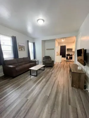 a living room with a couch and a table at Triple Play Apt 1 All Star Baseball Rentals in Oneonta